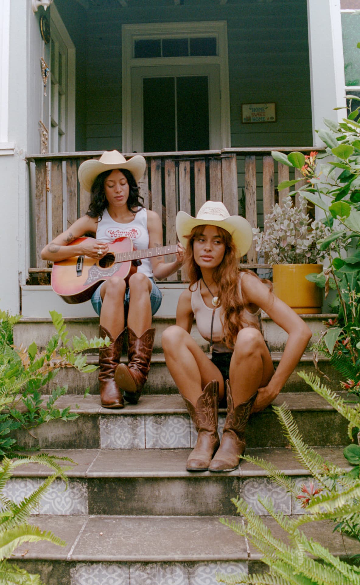 Musicians in Wrangler on porch steps