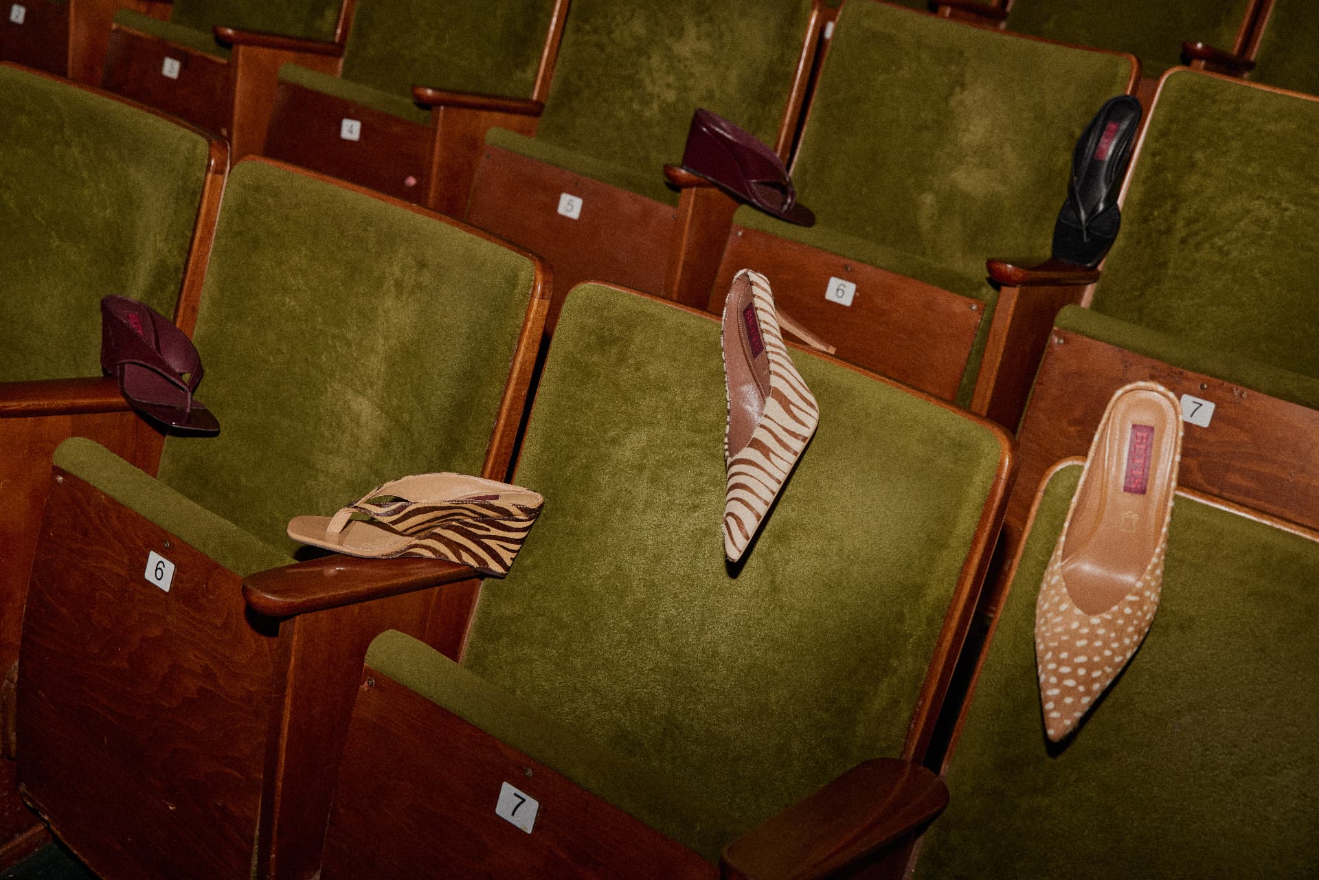 A selection of Betts heels and mules placed on retro cinema seats